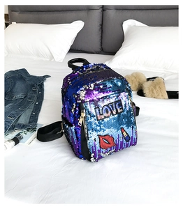 Detailed view of sequins backpack featuring embroidered LOVE and red lips patterns