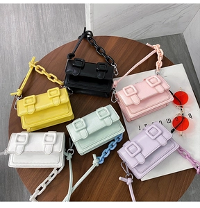 Flat lay of small crossbody messenger bags in six pastel colors with metal chains