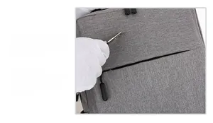 Detail showing grey business backpack with scratch-resistant and waterproof fabric texture