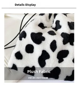 Close-up view showing the soft texture and cow pattern of the faux fur shoulder bag material