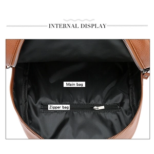 Detail showing the spacious main compartment and metal zipper inner pocket of the backpack