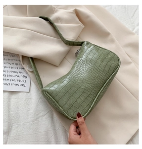 Détails de la texture croco vert en cuir PU sur un sac à bandoulière baguette vintage