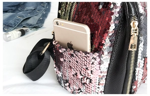 Close-up of side pocket on sequined backpack showing phone storage and leather texture