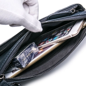 Detail view of the spacious black lychee leather interior and secure zipper closure