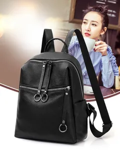 Detail shot of black washed PU leather backpack featuring silver ring zippers and side pockets