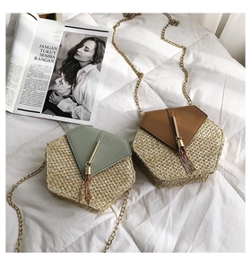 Detail of hexagonal straw crossbody bags with morandi green leather and gold tassel