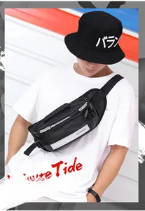 Close-up of black waterproof nylon waist bag with reflective strip and silver zippers