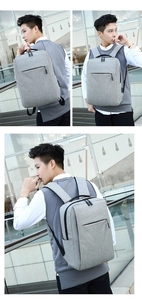 Detailed side and front view of a grey minimalist business laptop backpack for daily commuting