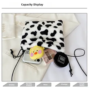 Macro shot showing internal capacity of the cow print plush bag with daily essentials