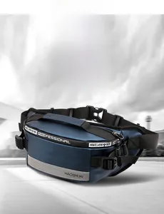 Detail of navy blue sports fanny pack showing waterproof fabric and reflective strip