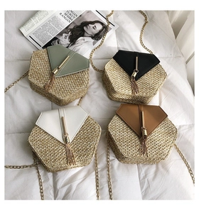 Detailed view of woven crossbody bags in four colors with gold chains and tassels