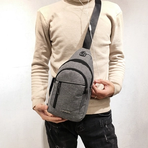 Gray casual crossbody chest bag with earphone port and adjustable strap for outdoor use