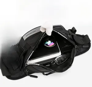 Detail view of the multi-layer interior space in a black nylon sports waist bag