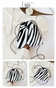 Detail view of zebra print plush drawstring bag with soft faux fur texture