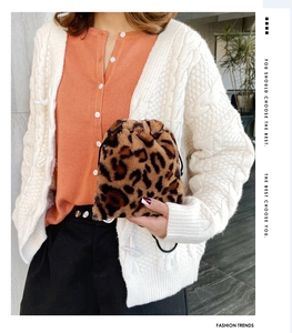 Detail view of leopard print faux fur bucket bag with drawstring closure and soft texture