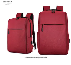 Detail view of burgundy business backpack with integrated USB charging port and textured fabric