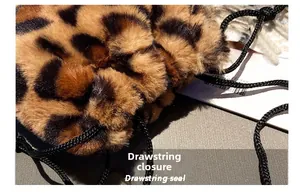 Detail shot of leopard print faux fur bucket bag with a black woven drawstring closure