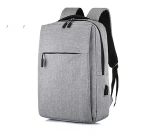 Detail view of a light grey business backpack featuring a side USB charging port
