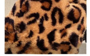 Close-up of soft leopard print faux fur fabric showing dense fibers and plush texture