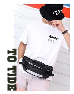 Detail of black sports fanny pack with reflective strip and adjustable buckle strap
