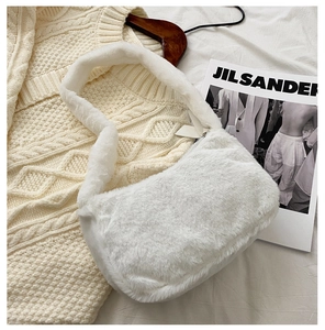 Close-up of the plush texture and metal zipper on this white fluffy shoulder bag