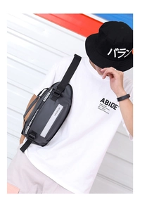 Detail of the gray waterproof nylon waist bag with reflective safety strip and brand logo