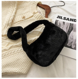 Close-up of black plush shoulder bag featuring soft faux rabbit fur and thick strap