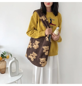 Close-up of soft plush brown teddy bear patterned tote bag with fuzzy texture detail
