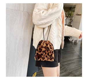 Close-up of fluffy leopard print faux fur bucket bag with a drawstring closure