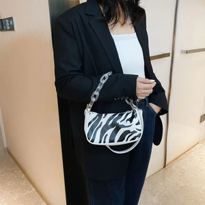 Fashionable zebra print baguette shoulder bag with acrylic chain and white leather strap