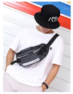 Detail view of grey waterproof nylon sports chest bag with multiple zipper compartments