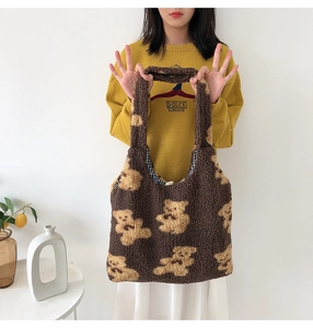 Detail of plush brown teddy bear tote bag showing soft lamb wool texture and yellow pattern