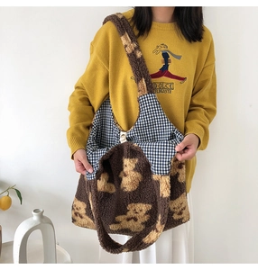 Detail view of the soft teddy bear plush tote bag featuring blue plaid inner lining