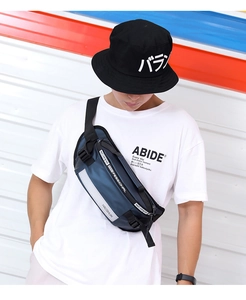 Close-up of the adjustable buckle and reflective safety strip on the navy crossbody bag