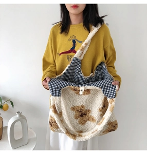 Detail of plush teddy bear tote bag showing soft sherpa texture and blue plaid lining