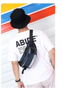 Detail of navy blue nylon sports chest bag with reflective safety strip and zipper