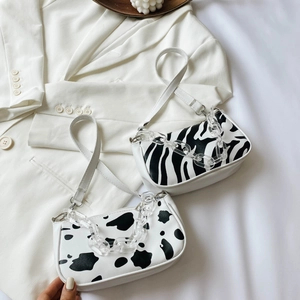 Retro cow print baguette bag with white leather and acrylic chain shoulder strap