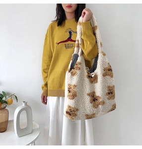 Macro shot of fluffy cream teddy bear tote bag with soft lamb wool texture and plaid lining