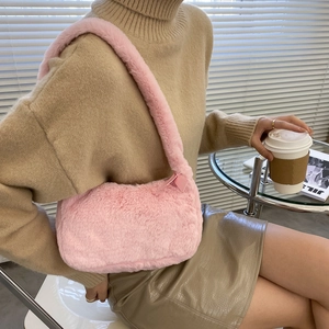 Pink fluffy faux fur shoulder bag for women with decorative bow and plush strap