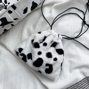 Winter plush cow pattern drawstring bag with soft faux fur texture and black string cords
