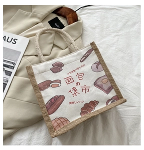Detail of canvas tote bag with bread illustration and sturdy jute rope handles
