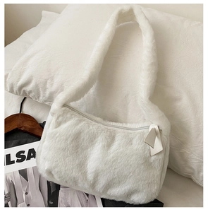 Detailed view of white fluffy faux fur underarm bag with zipper closure and soft texture