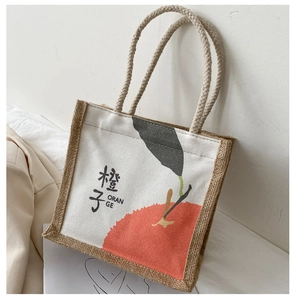 Close-up of canvas tote bag with orange print and natural jute splicing texture