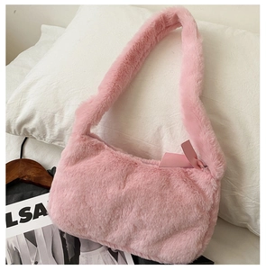Detailed macro view of soft pink faux fur shoulder bag with silver metal zipper closure