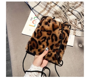 Close-up of leopard print faux fur bucket bag with drawstring and soft plush texture