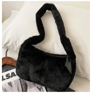 Detail of black faux fur shoulder bag texture with soft plush fabric and leather zipper pull