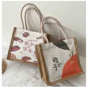 Close-up of minimalist canvas tote with jute base featuring hand-drawn bread illustrations