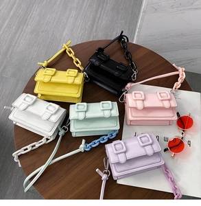 Detailed arrangement of candy-colored mini crossbody bags with dual buckle and plastic chains