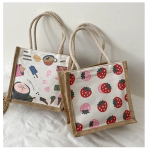 Detail of canvas and jute tote bags with coffee print and red strawberry patterns