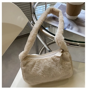 Detailed view of the soft faux fur texture and ivory zipper of this plush shoulder bag